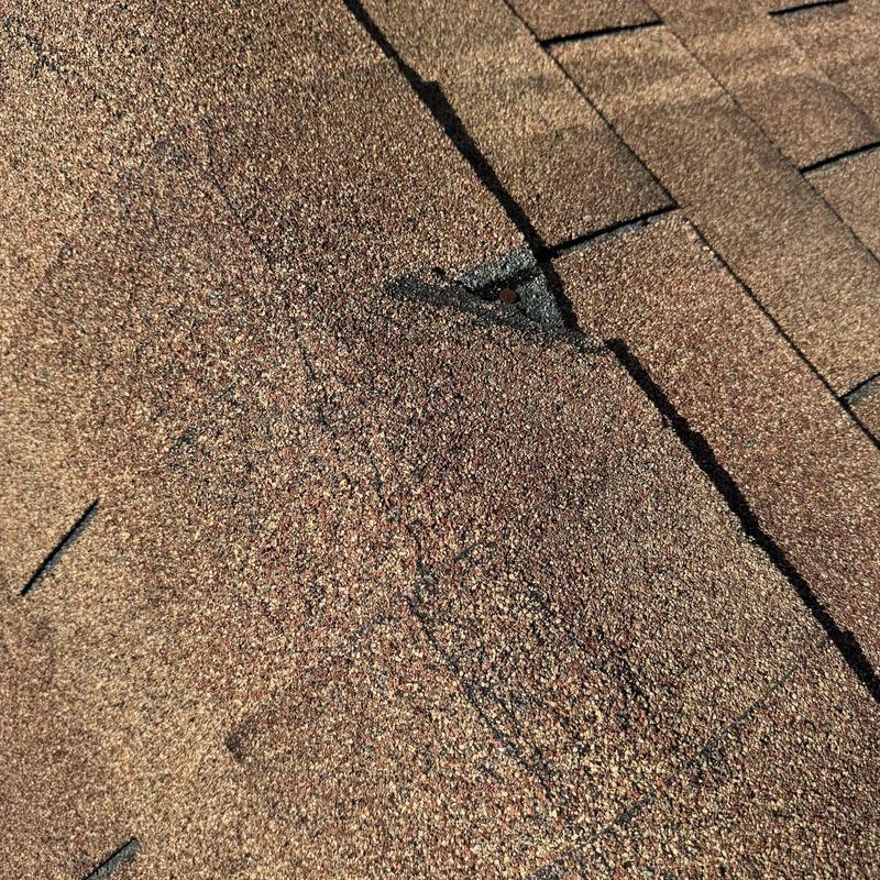 Roof shingles with hail damage close-up view