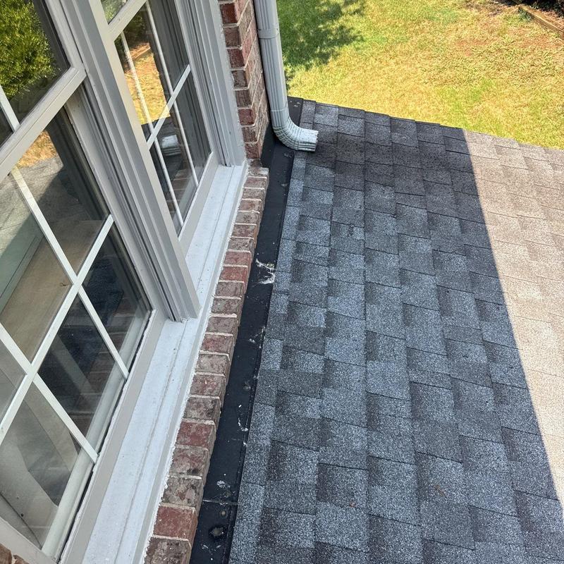 Shingle roof and window flashing with gutter downspout