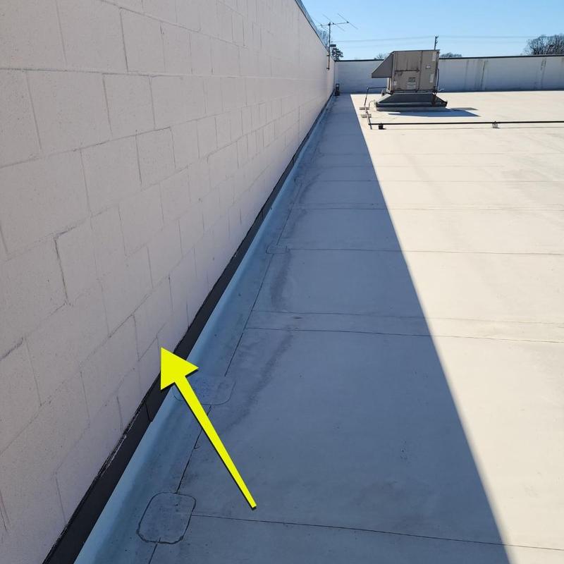Flat TPO roof wall flashing with yellow arrow indicator Flat TPO roof wall flashing with yellow arrow indicator