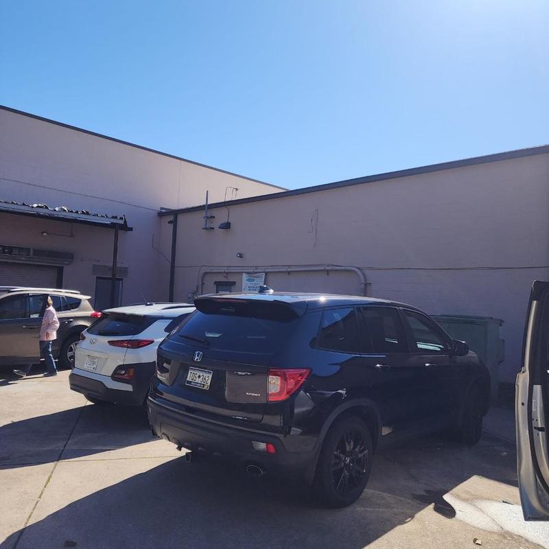 Flat TPO roof with parked SUVs in sunny lot Flat TPO roof with parked SUVs in sunny lot