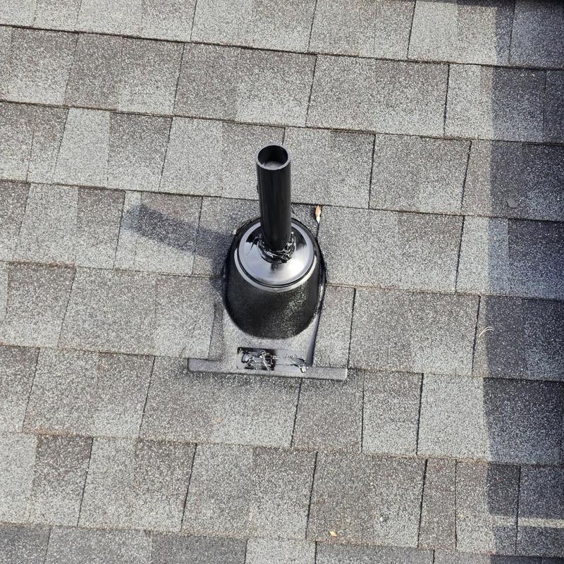 Roof vent flashing with new sealant on asphalt shingles Roof vent flashing with new sealant on asphalt shingles