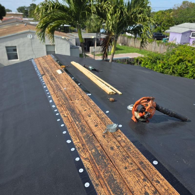 Flat roof decking with repair tools in Miami Gardens