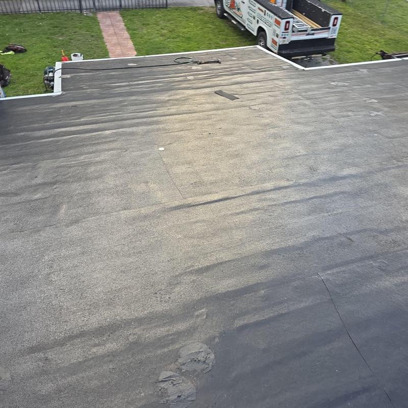 Flat roofing with visible wear and patch on surface