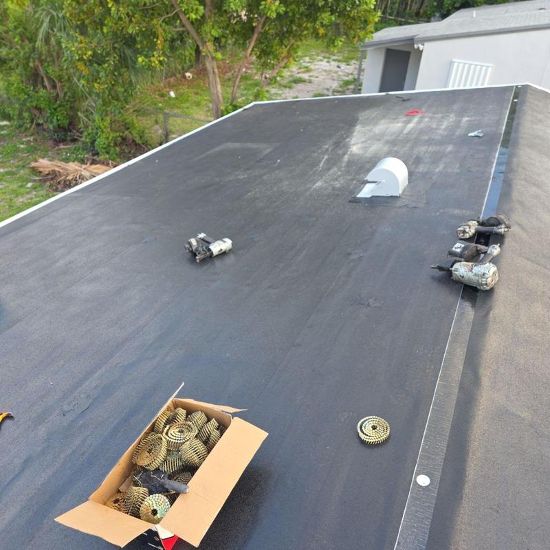 TPO flat roof membrane with roofing tools and supplies
