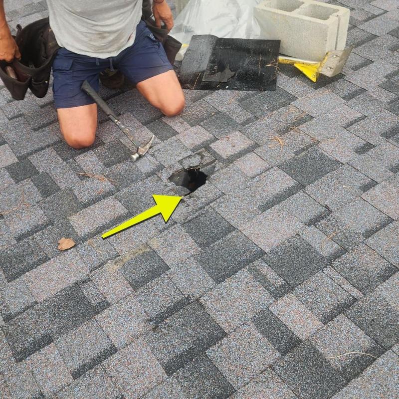 Roof shingle with storm damage hole and repair tools Roof shingle with storm damage hole and repair tools