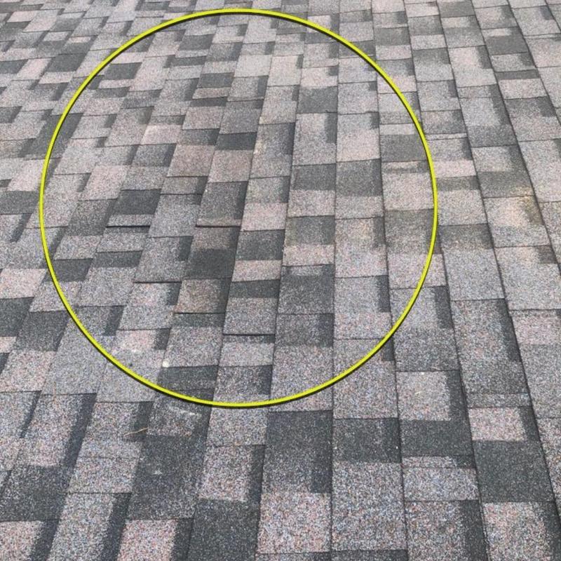 Asphalt shingle roof with lifted shingles after storm damage Asphalt shingle roof with lifted shingles after storm damage