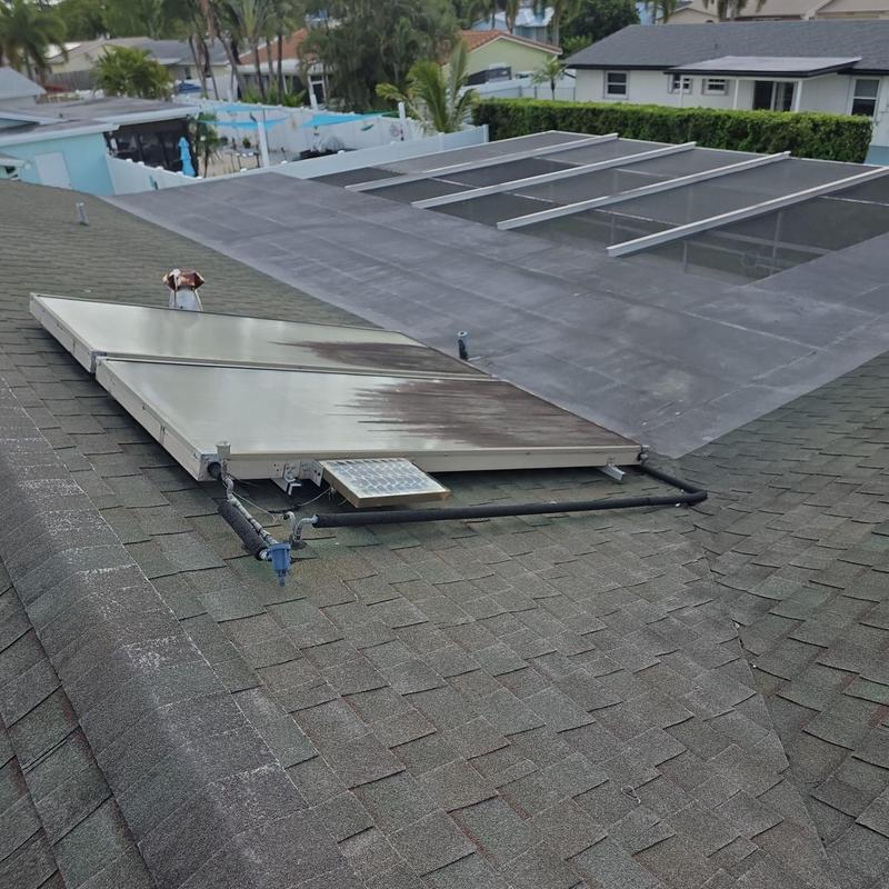 Solar pool heater panels on shingle roof in Miami