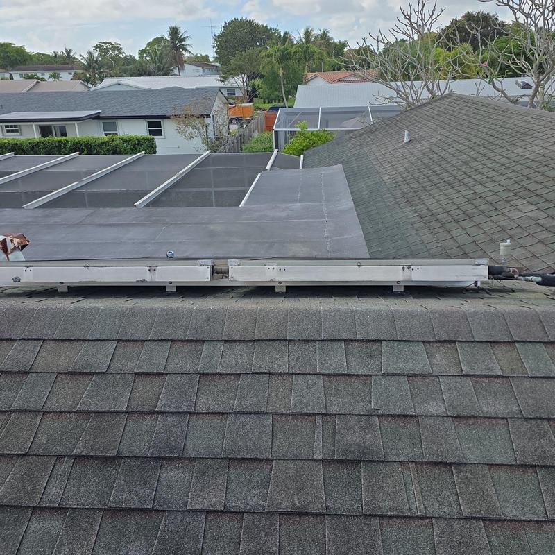 Shingle roof with flat capsheet overlap in Miami backyard