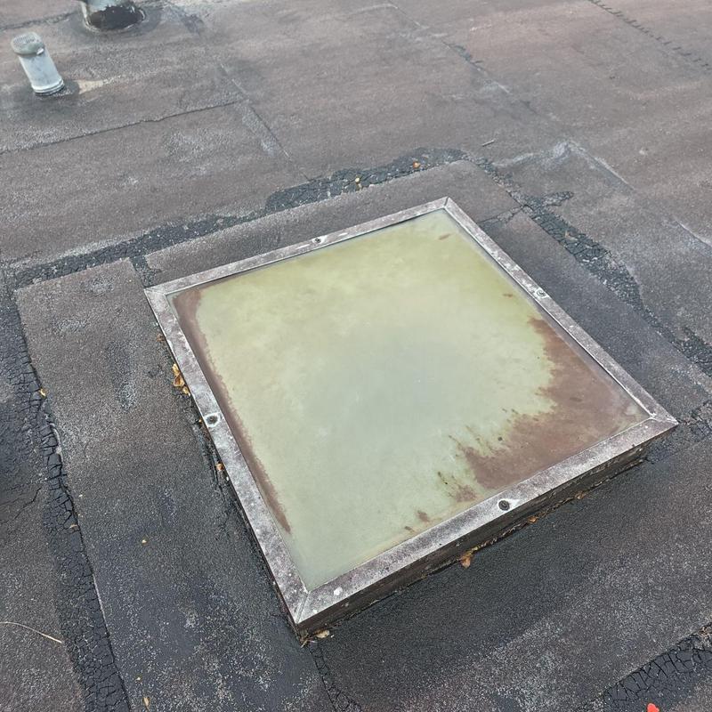 Flat roof skylight with rust and wear damage