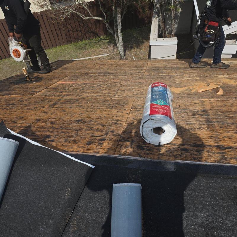 Roof decking installation with rolled roofing materials