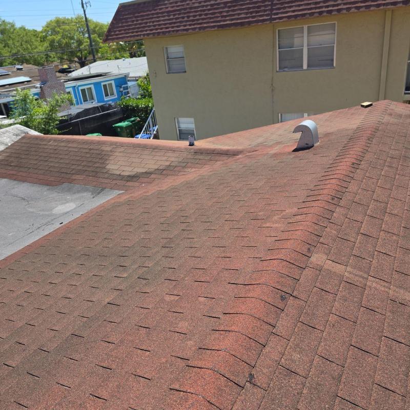 Asphalt shingle roof with visible wear and patching