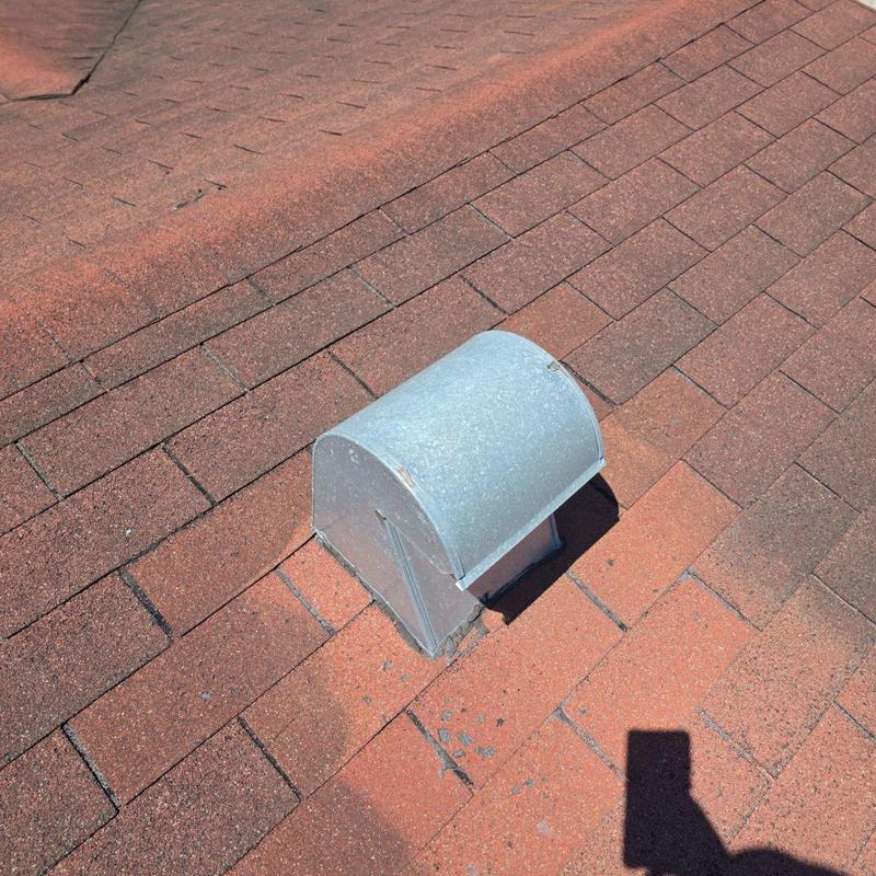 Metal roof vent on red asphalt shingle roof