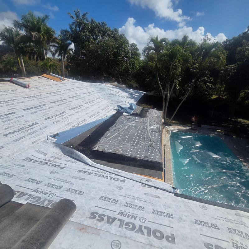 Tile roof underlayment installation on flat roof near pool