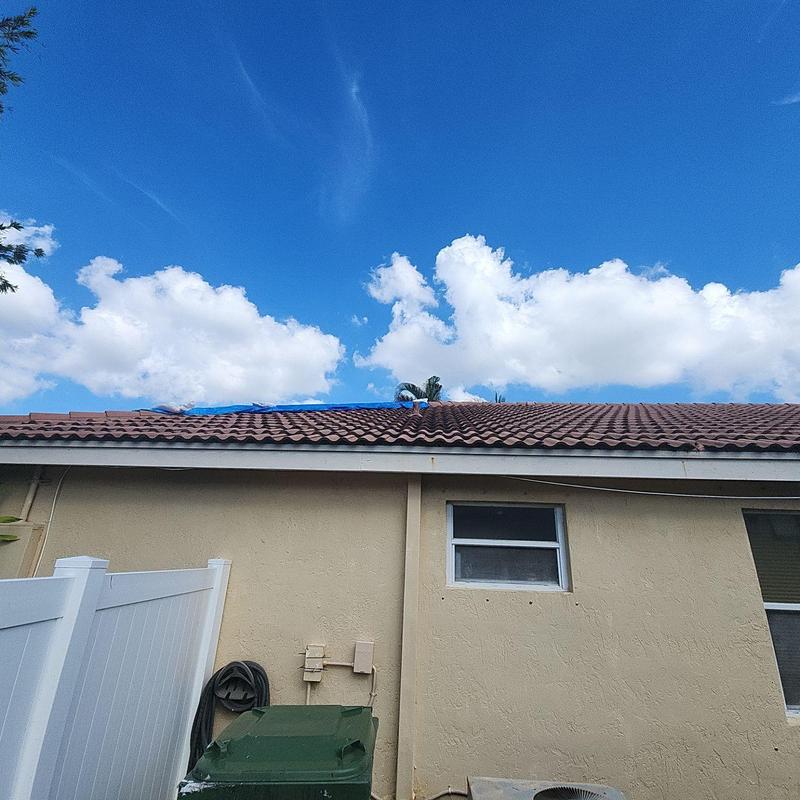 Concrete tile roof with weathered tiles and vents