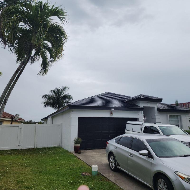 Concrete tile roof on single-story house with driveway