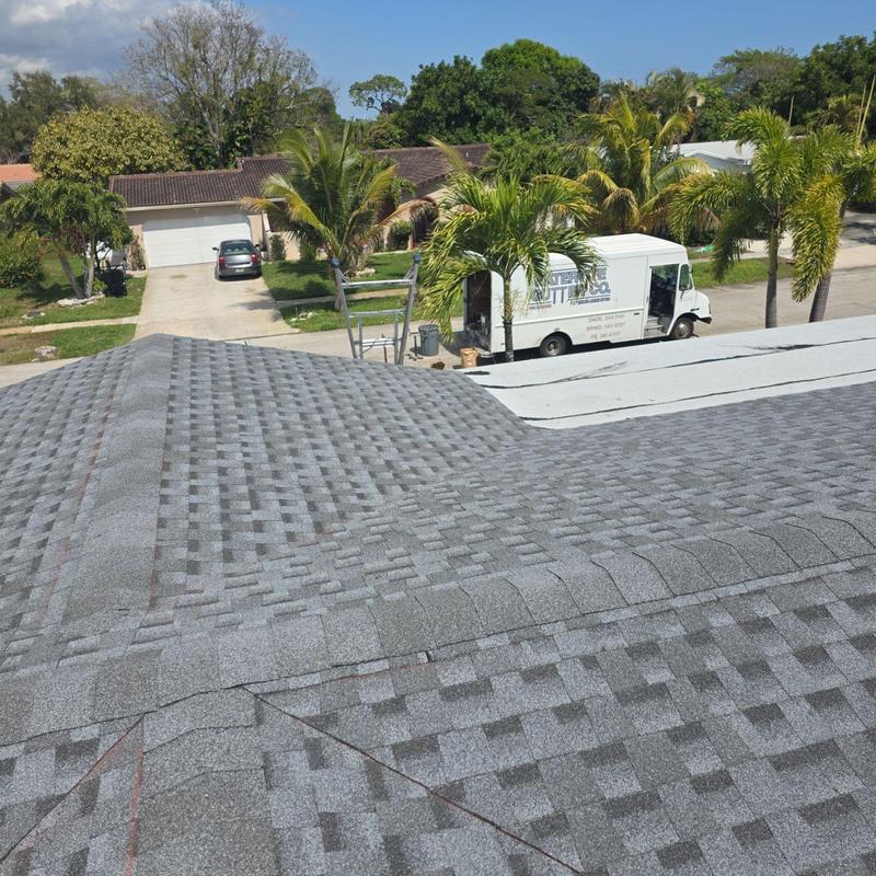 Shingle roof and flat roof replacement with truck nearby