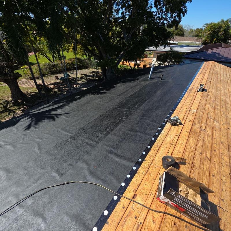 Roof underlayment installation on wooden deck roof