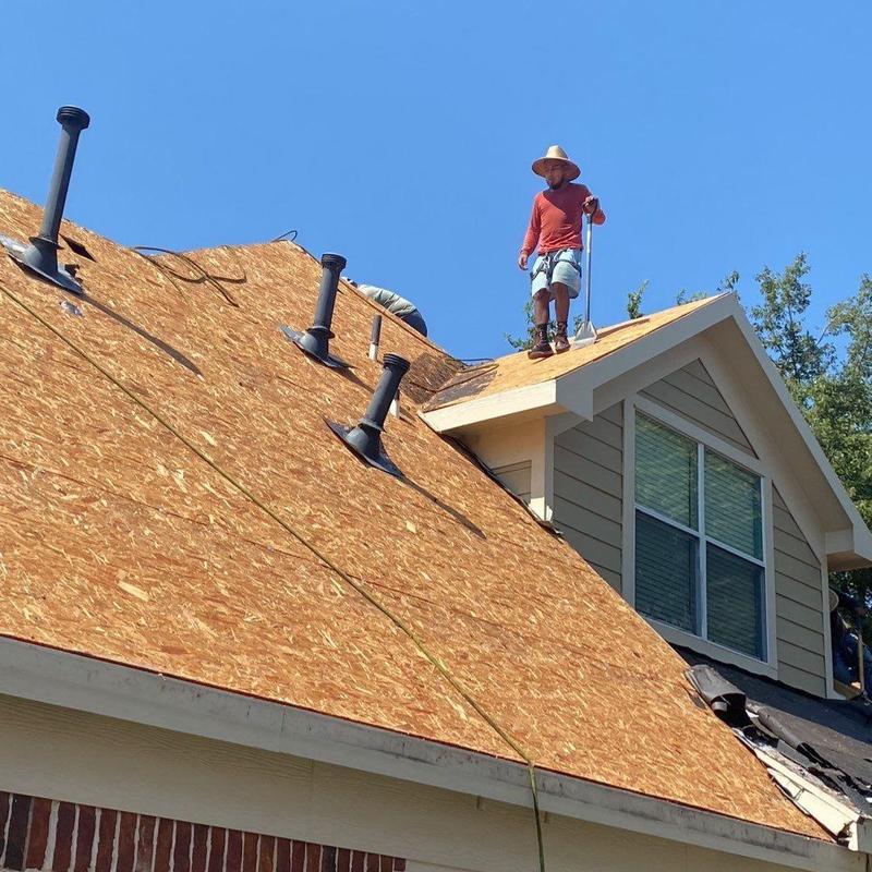 Wood roof sheathing installation on steep residential roof