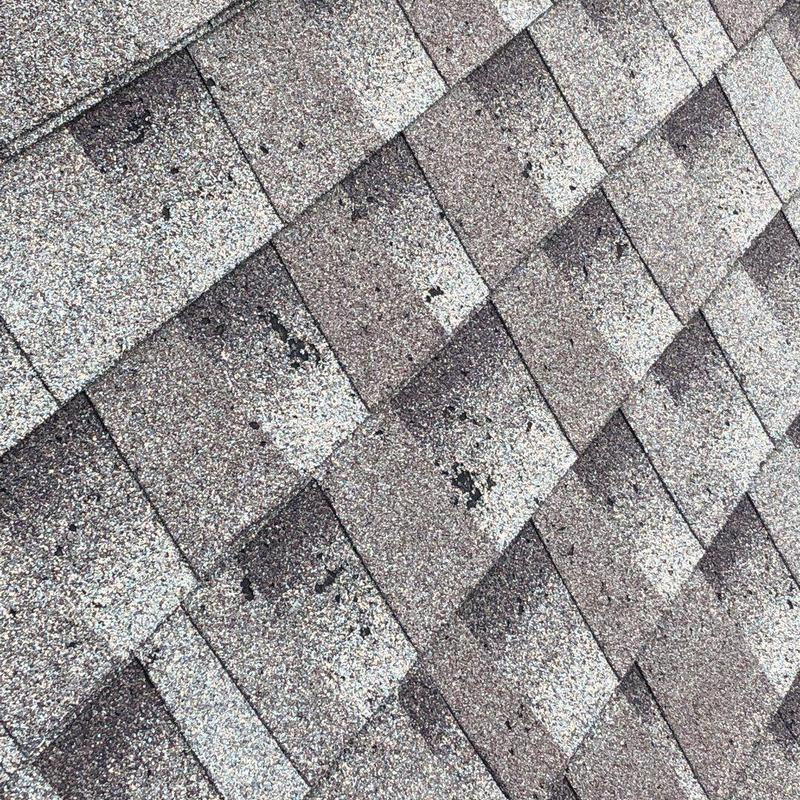 Asphalt shingles with hail damage close-up pattern