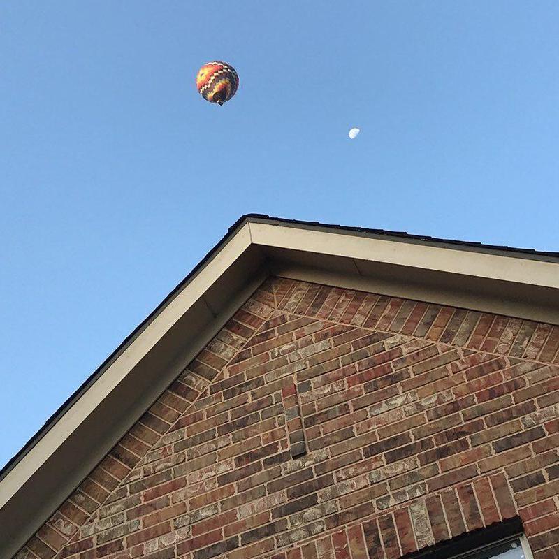 GAF Timberline shingle roof with clear blue sky and hot air balloon