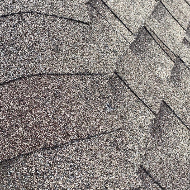GAF Timberline asphalt shingles with hail damage spot