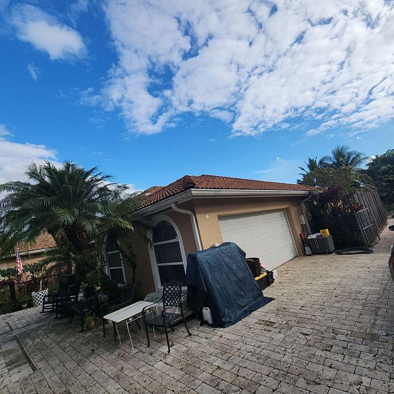 Tile Roof inspection with palm trees and driveway