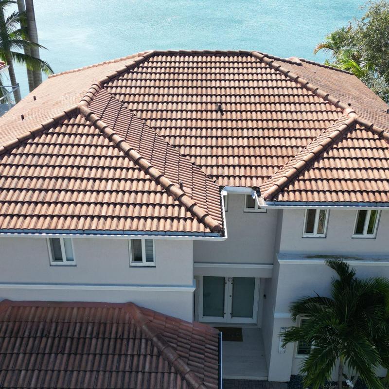 Concrete tile roof with multi-hip design over house