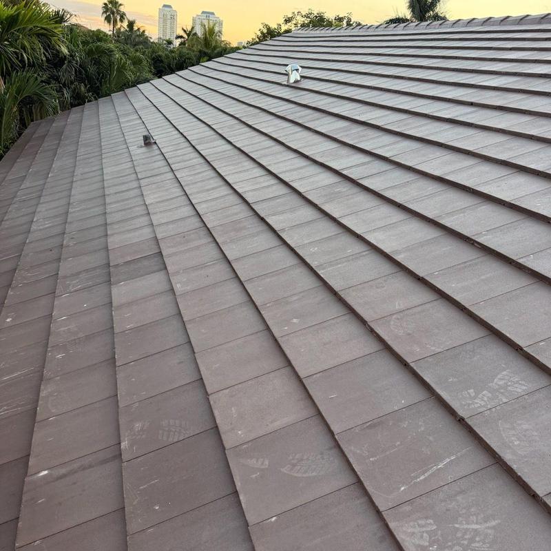 Concrete tile roof with vent pipes at sunset
