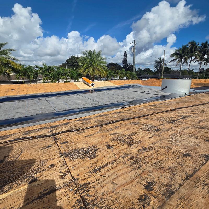 Flat roof underlayment installation on plywood deck