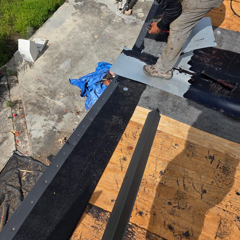 Flat roof membrane installation with metal flashing