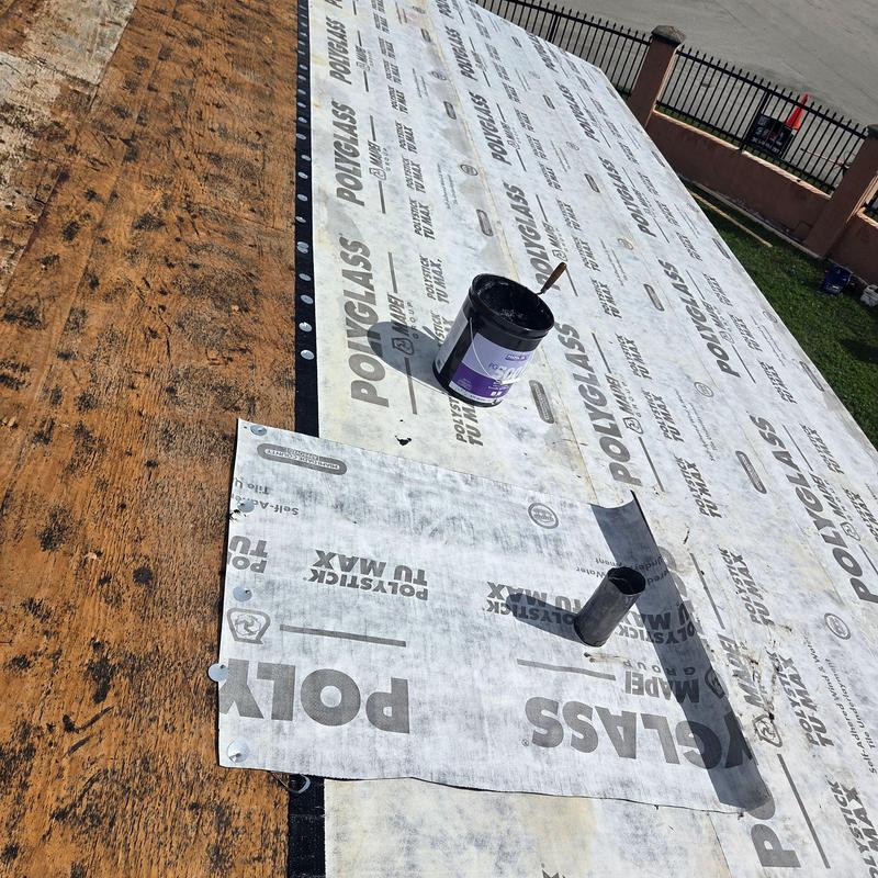 Flat roof waterproof membrane installation on plywood deck
