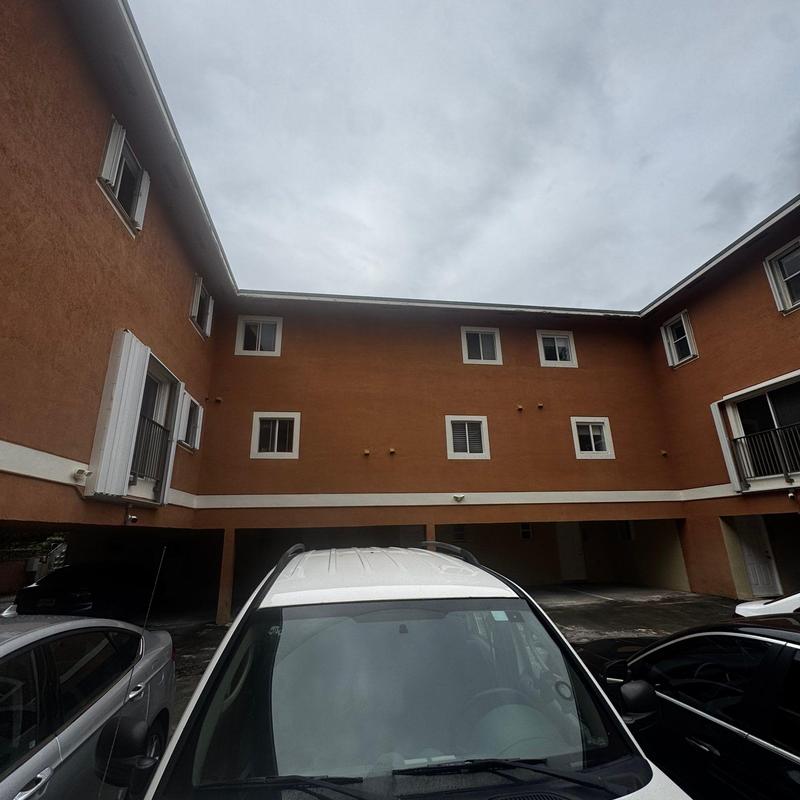 Commercial flat roof with drainage system and parked cars