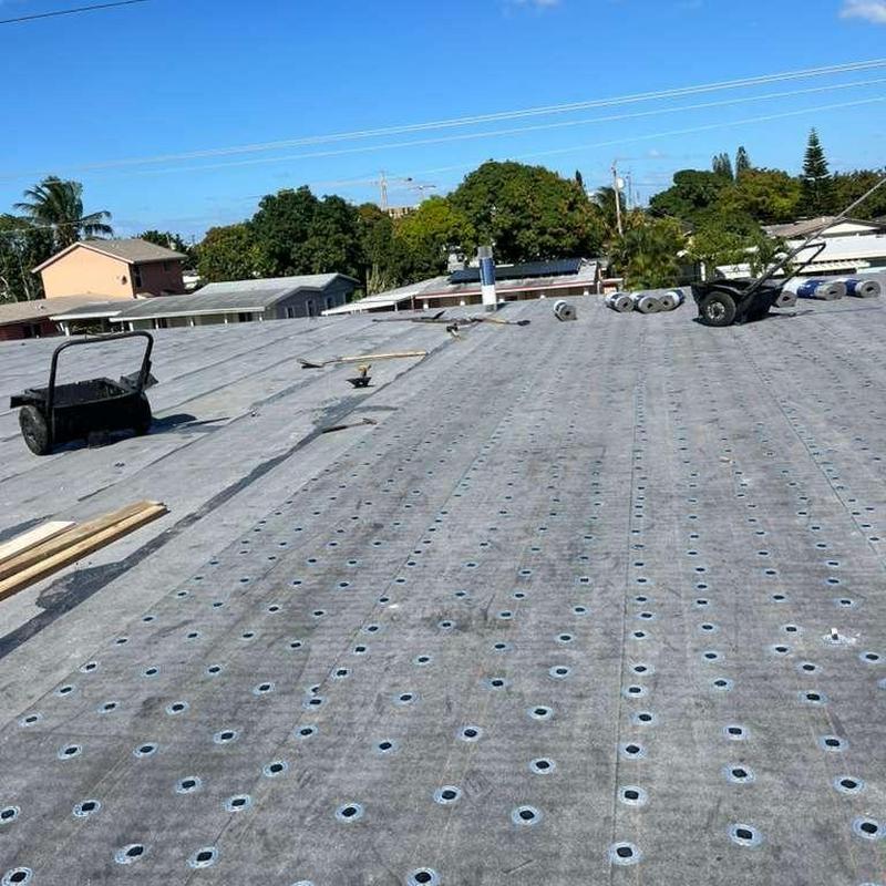 Commercial flat roof membrane with fasteners exposed Commercial flat roof membrane with fasteners exposed