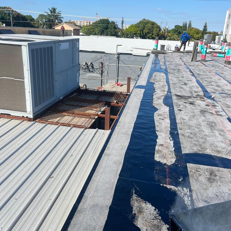 Flat roof membrane installation with HVAC unit nearby Flat roof membrane installation with HVAC unit nearby