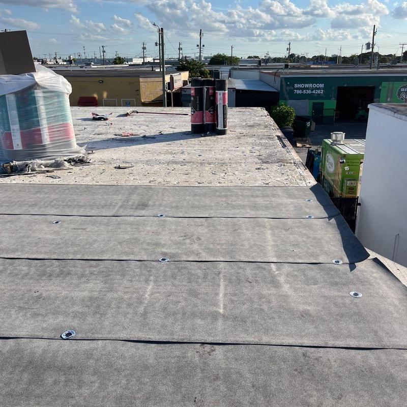 Commercial flat roof membrane installation in progress Commercial flat roof membrane installation in progress