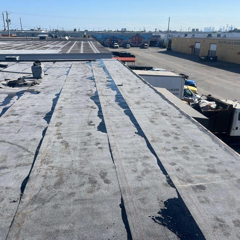 Commercial flat roof with visible repair seams Commercial flat roof with visible repair seams