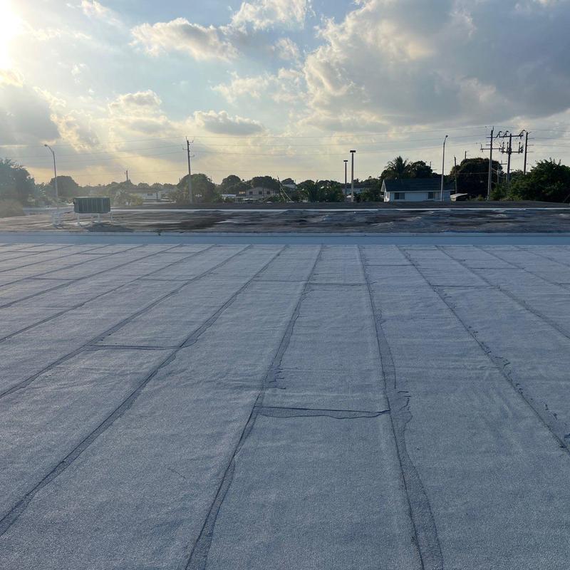 Commercial flat roof with new membrane installation Commercial flat roof with new membrane installation