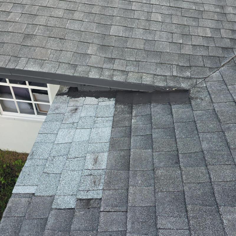 Asphalt shingle roof patch near window and flashing