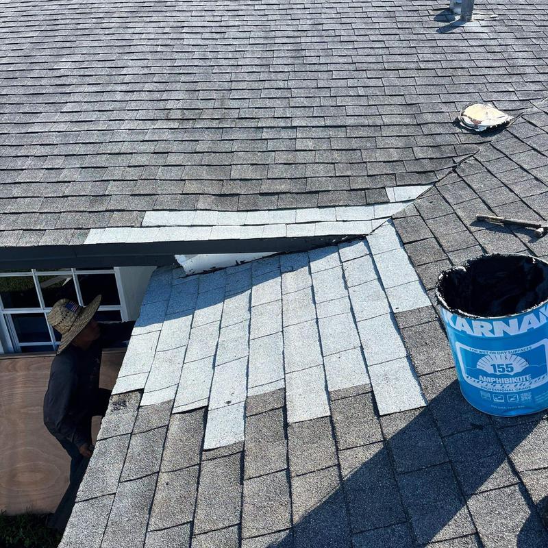 Shingle roof section with new shingles installation