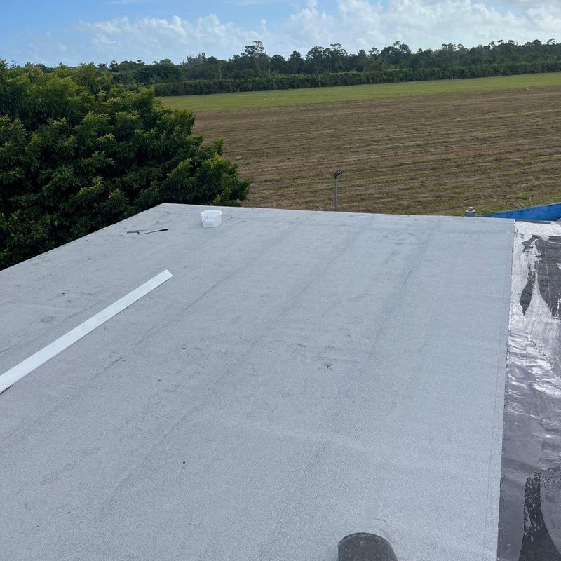Commercial flat roof membrane installation with surrounding field Commercial flat roof membrane installation with surrounding field