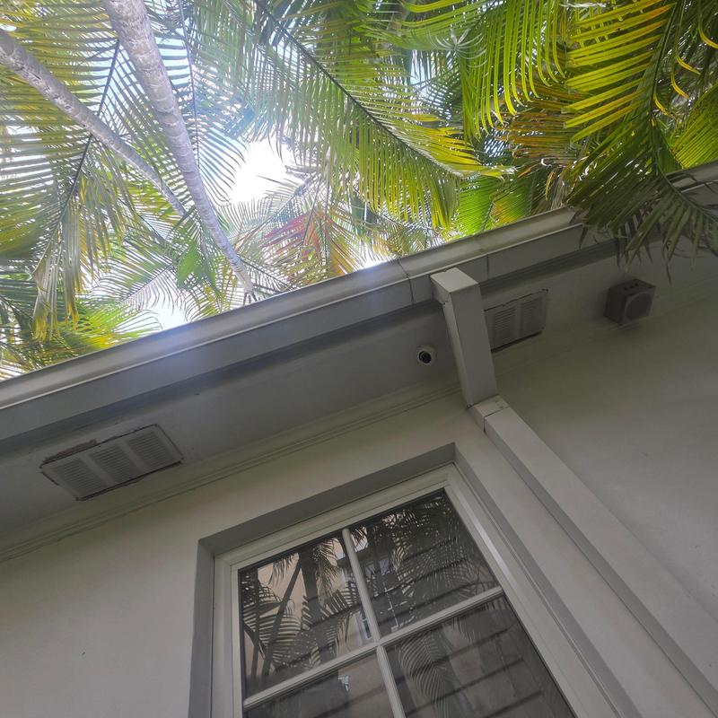 Roof gutter and downspout on residential house exterior