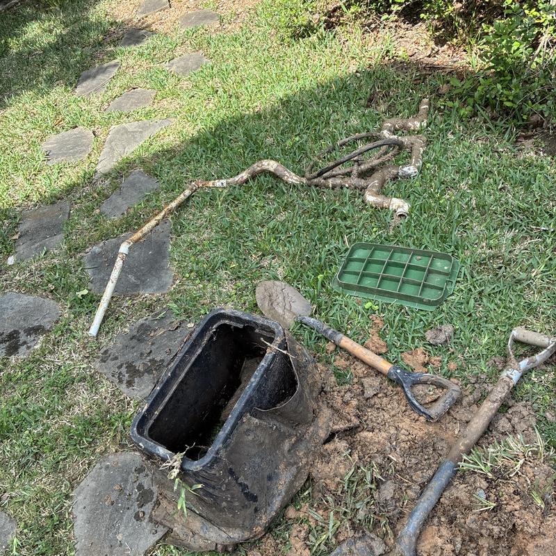 Yard irrigation valve box with old pipe removal and tools