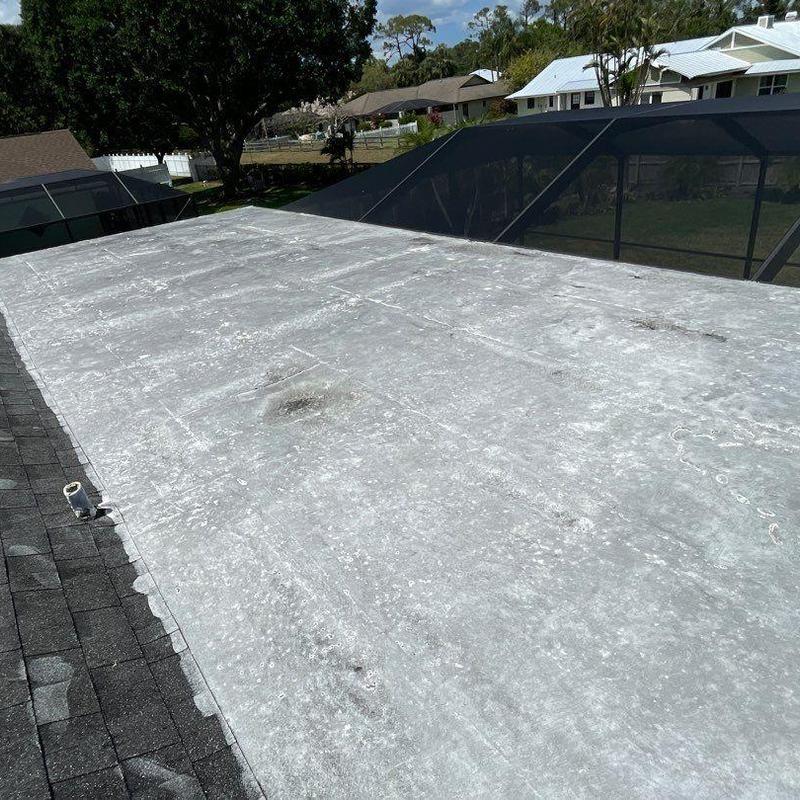 Flat roof membrane with visible wear and damage