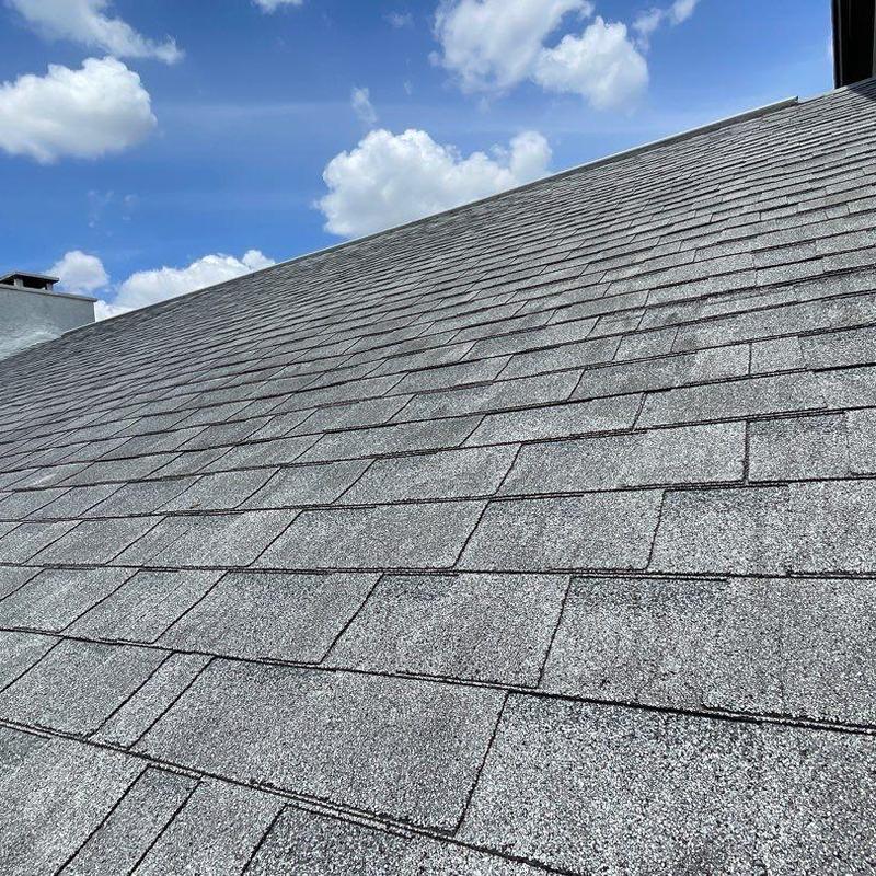 Asphalt shingle roof with visible wear and damage