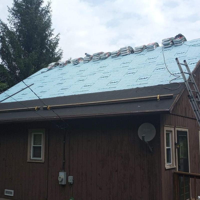 Roofing underlayment installation on residential roof Roofing underlayment installation on residential roof