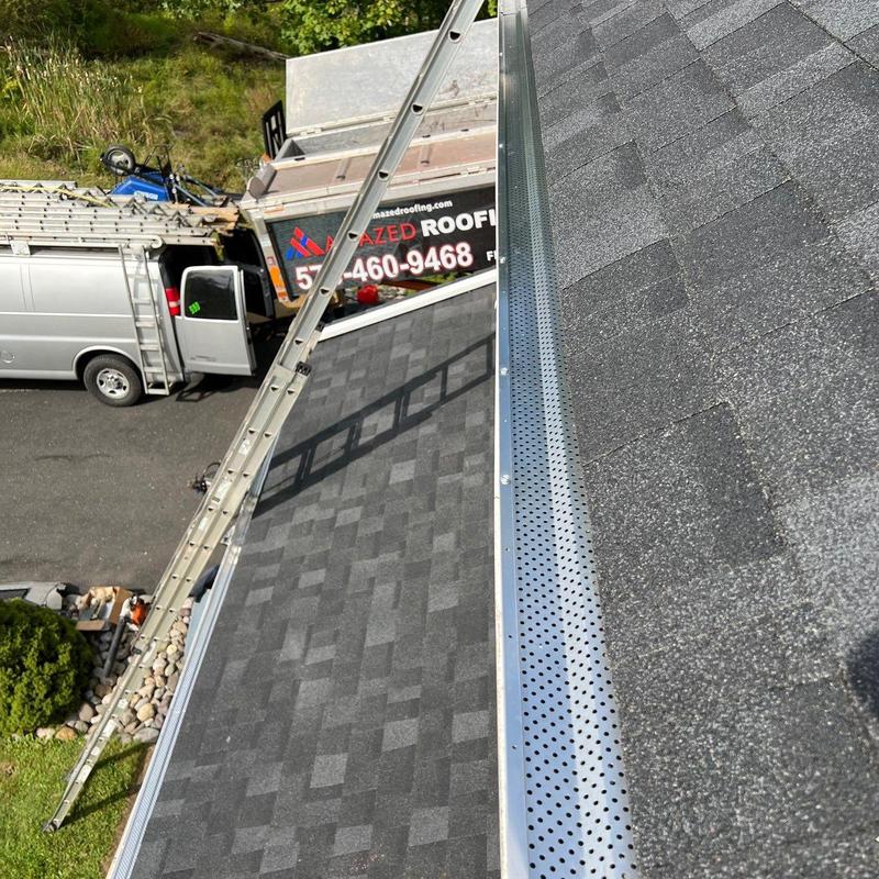 Perforated gutter guards installed on asphalt roof Perforated gutter guards installed on asphalt roof