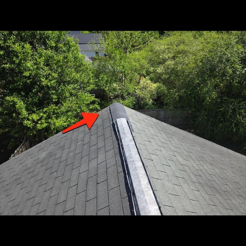 Ridge shingles and roof ridge vent with repair arrow Ridge shingles and roof ridge vent with repair arrow