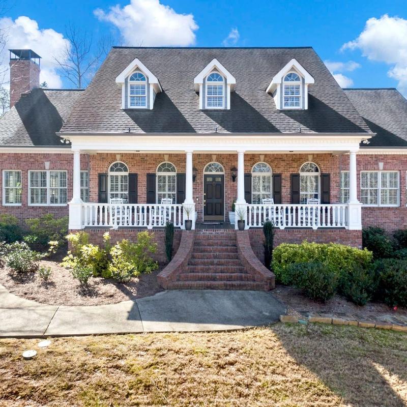 Asphalt shingle roof on large brick house with porch