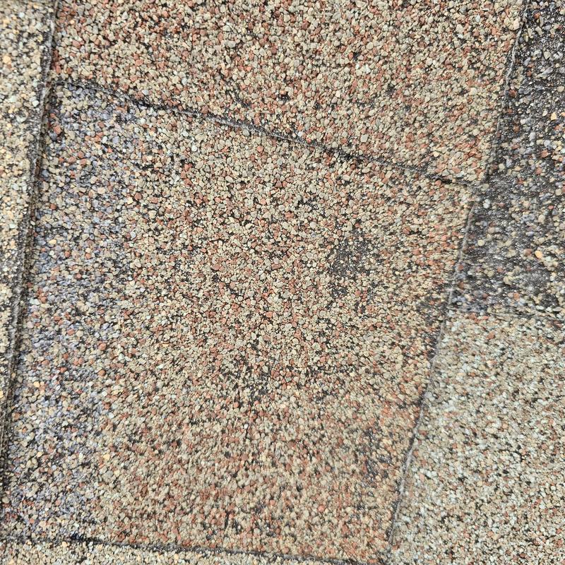 Asphalt roof shingle hail damage close-up
