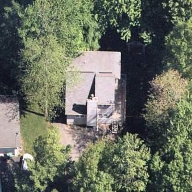 New residential roof installation surrounded by trees New residential roof installation surrounded by trees